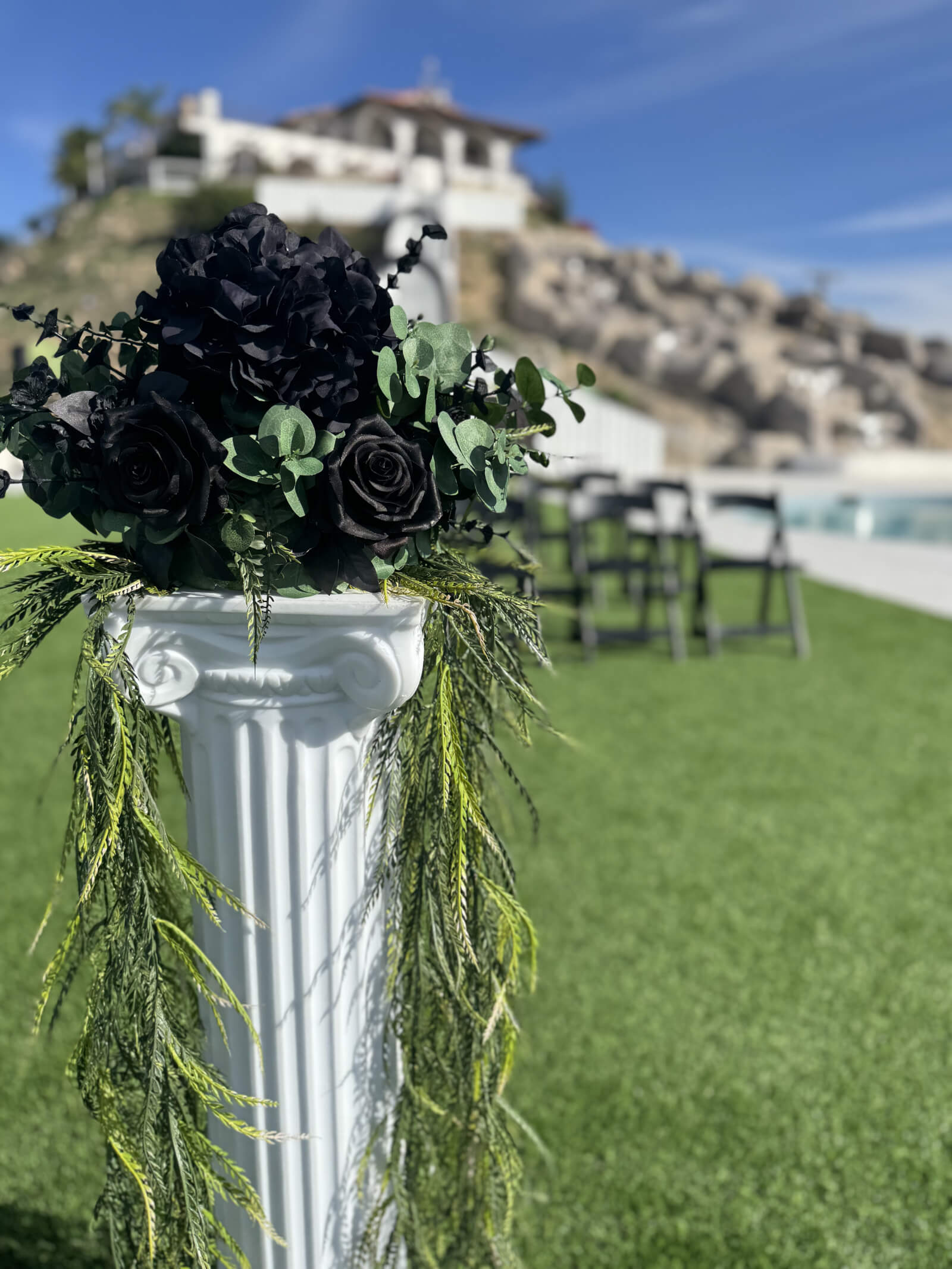 Black Rose floral column at a wedding ceremony