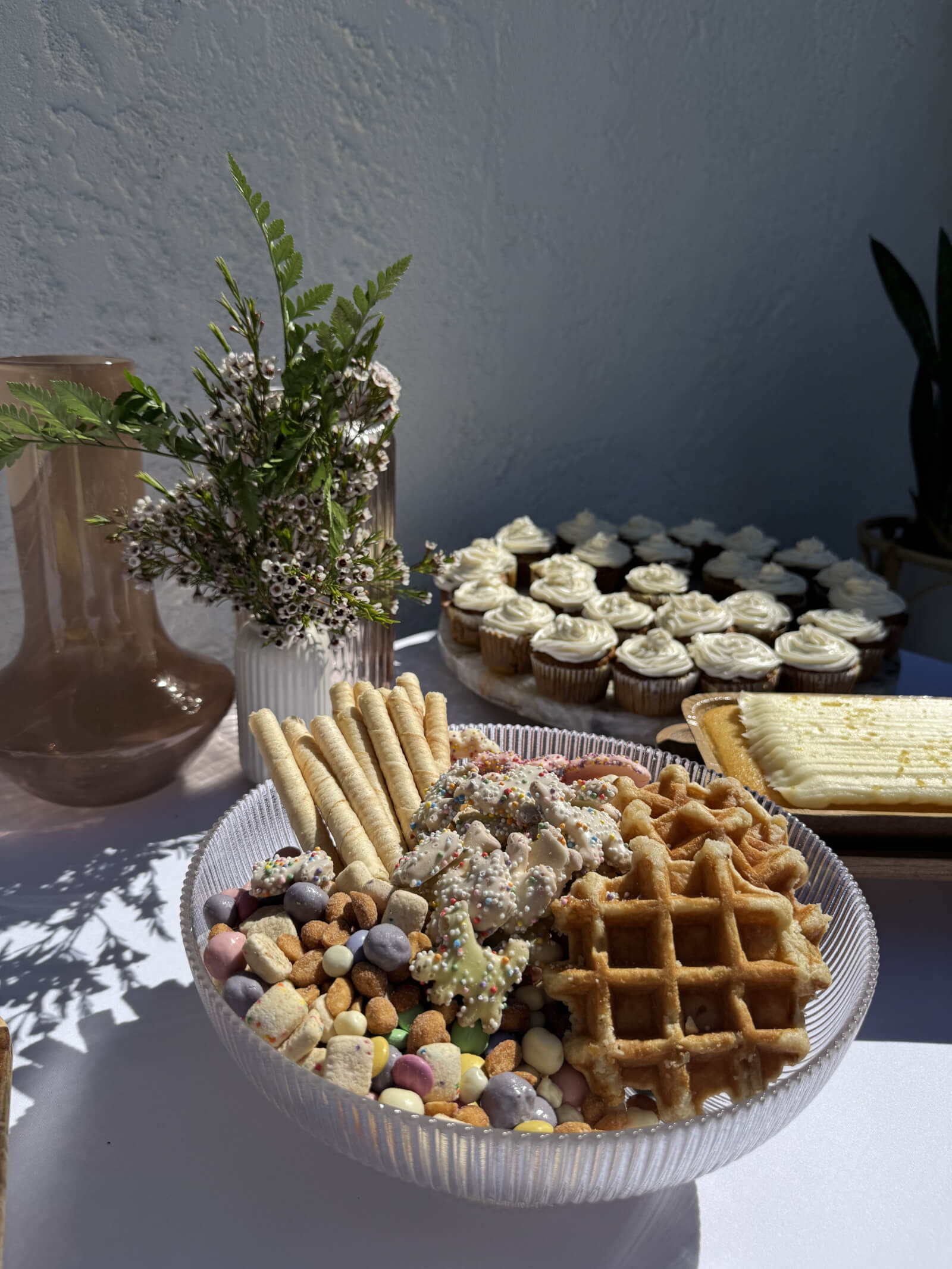 Bridal shower brunch spread with florals and curated treats